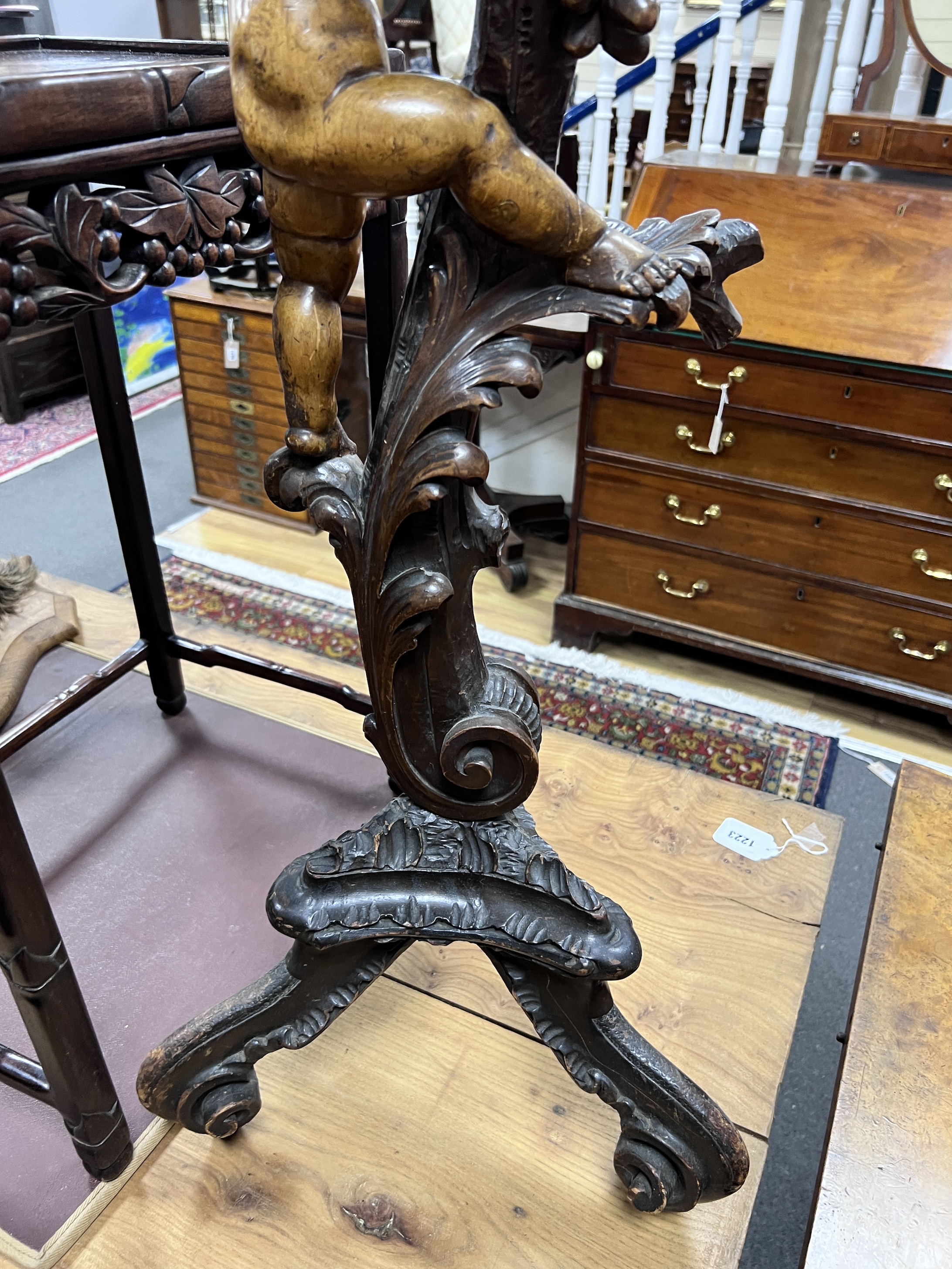 An early 20th century Italian carved walnut and softwood torchere, height 90cm